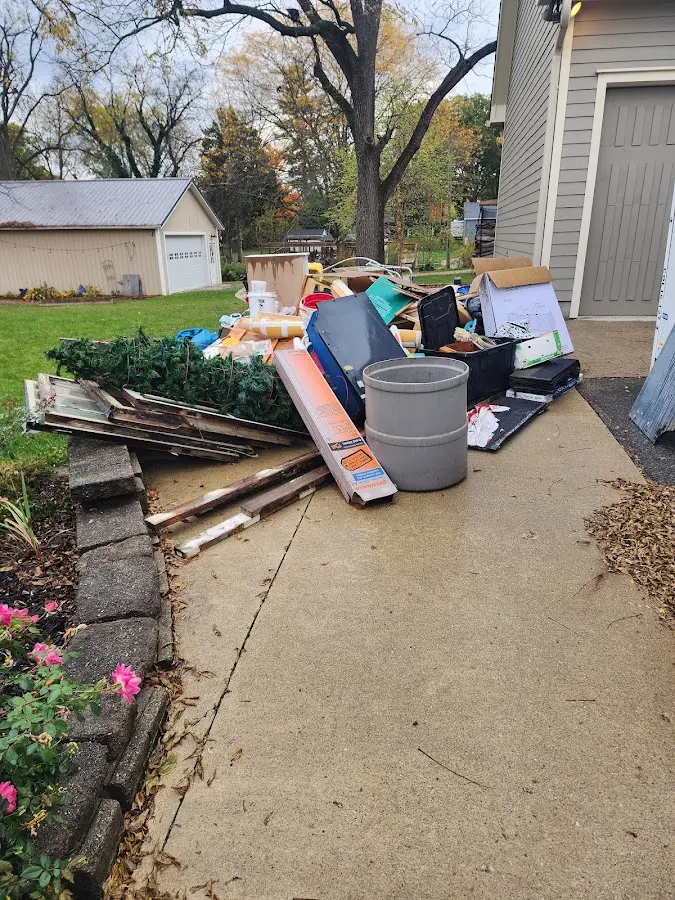 Dumpster being loaded with debris for 12 Yard Dumpster Rental in Hockessin